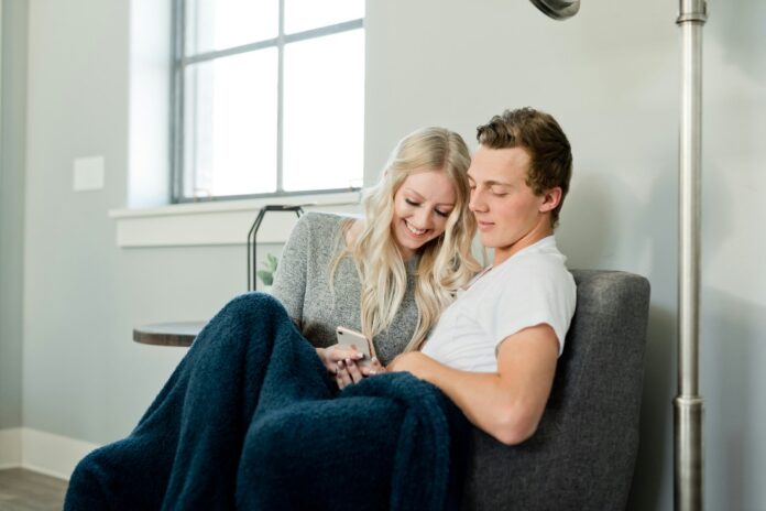 Lovebirds snuggle on the couch