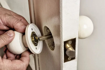 Close-up of a door lock showing signs of wear and tear on the latch and knob assembly
